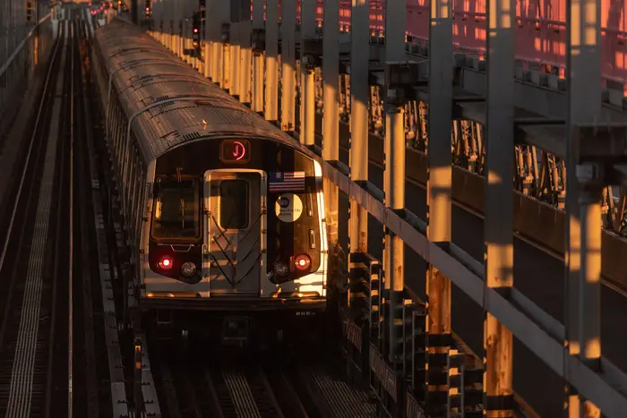 A subway train moves over the Williamsburg Bridge.